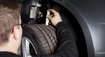 Mechanic is checking the skid depth of a tire